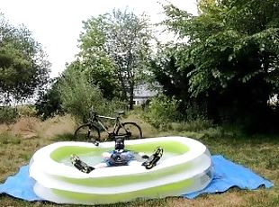 Cyclist pup in pool - cooling down and pawing off