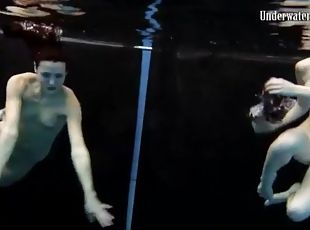 Skinny teens swim in the deep pool naked