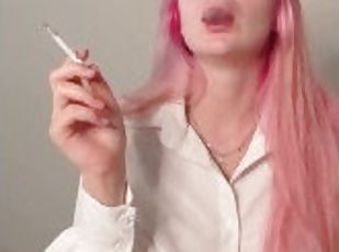 Girl with pink hair smokes a cigarette in a sexy shirt