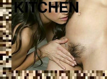 Pair of petite brunettes licking passionately in the kitchen