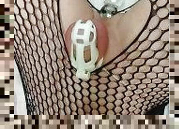 Locked sissy plays with a huge glass dildo.
