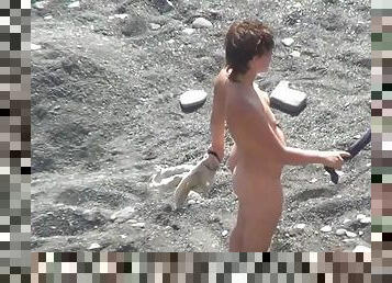 Sexy nudist is getting naked on the beach