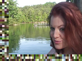 Cute red head pole dances at a lake