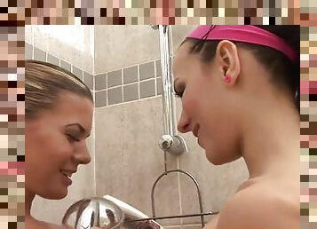 Two hot bitches toying with a dildo in the shower