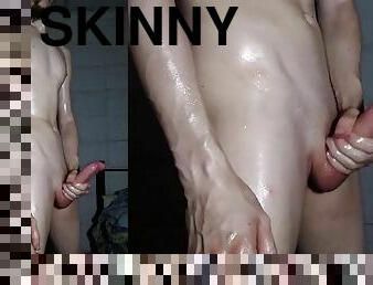 Skinny boy strips, then oils up and jerks off - huge cumshot video