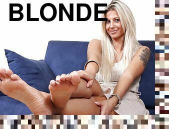 Hot blonde Samantha texting while resting in the sofa