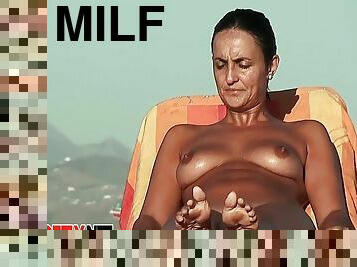Milf Filmed At A Nudist Beach While Taking Off Her Top. Nice