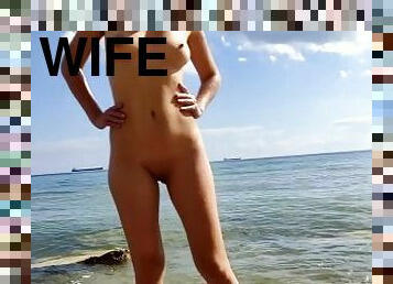 Alice walks naked on an empty nudist beach and enters the water for the first time this year