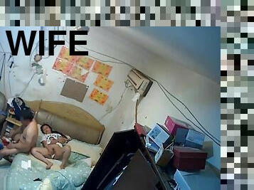The rented uncle goes to bed with his wife who is playing with her mobile p