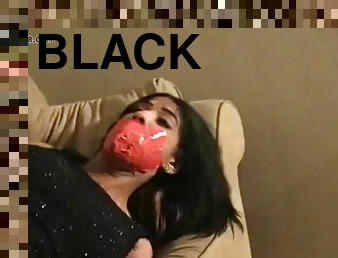 Black woman tied up and gagged with red tape
