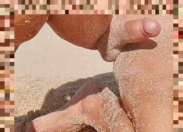 Sexy guy shows off his hard cock on a public beach - masturbation with sand on his body - risky