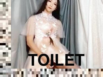 Cute ladyboy on a pretty dress pissing on the toilet wanking and cum semen