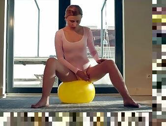 Sporty blonde fucks herself with the handle of her exercise ball