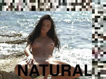 Sexy brunette Sasha C posing naked on the beach