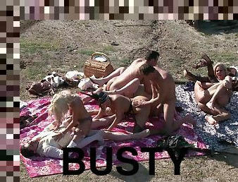 Four busty milfs in high heels get fucked by 4 men in outdoor orgy