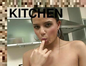 Sporty girl with perky tits plays with a toy in the kitchen