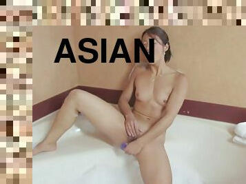 Asian babe in a bath enjoys masturbating