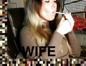 modest wife smokes a cigarette
