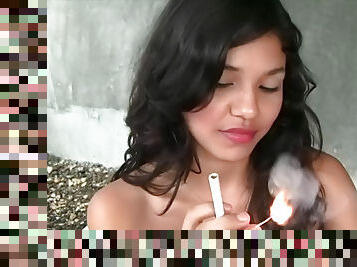 Asian babe is smoking a cigarette so hot