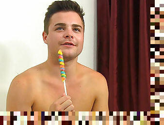 Cute boy sucks lollipop and talks