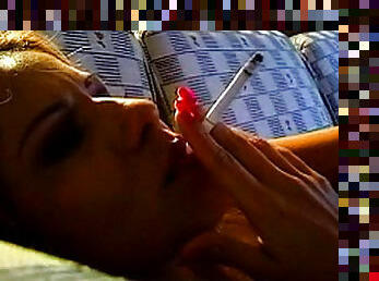 Close up on sexy girl blowing smoke