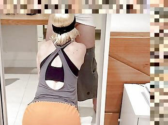 Masked blonde sucks cock kneeling and takes cumshot on her face.