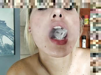 Hot naked blonde smoking a cigarette while playing with ice cubes