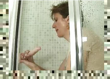 Busty whore practices fucking dildo in the shower