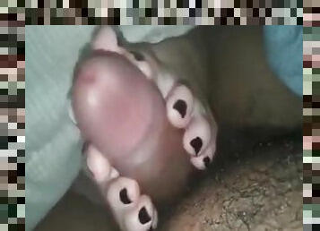 Pretty painted toenails on a GF giving a footjob