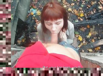Redhead gives him a sexy blowjob outdoors