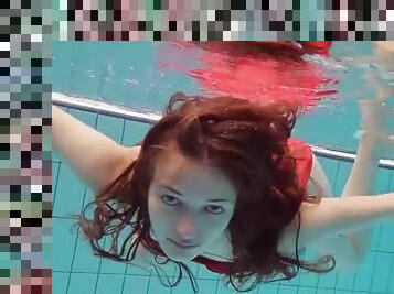 Teen in a pretty red dress slips into the pool