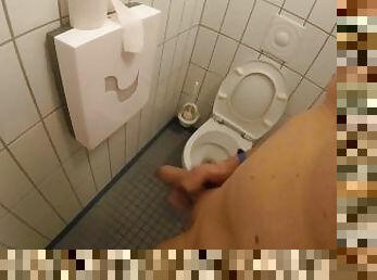 Naked jerking off and cum in the toilet next to a public shower room while people are pi and shower