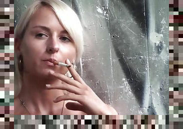 Lovely blonde teen smoking a cigarette outdoors by Femdom Austria