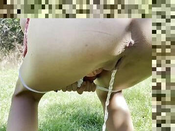 Petite teen pees in the garden